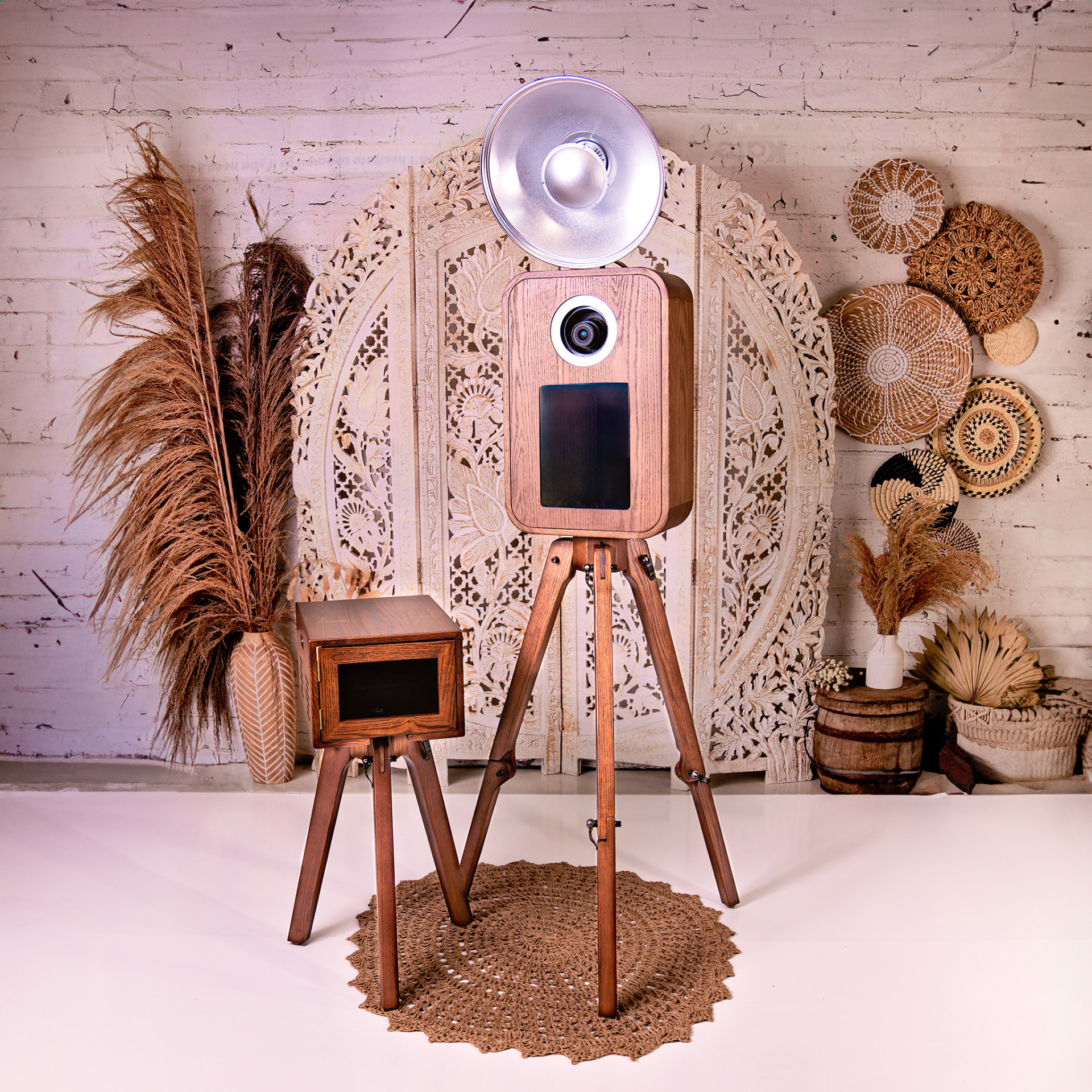 Vintage wooden photo booth on a tripod with boho backdrop